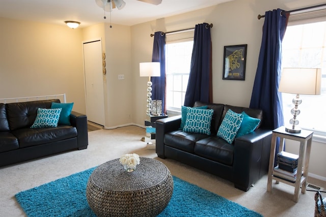 living room featuring ceiling fan and light colored carpet