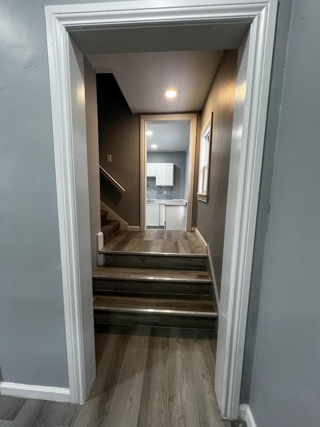 staircase with hardwood / wood-style flooring