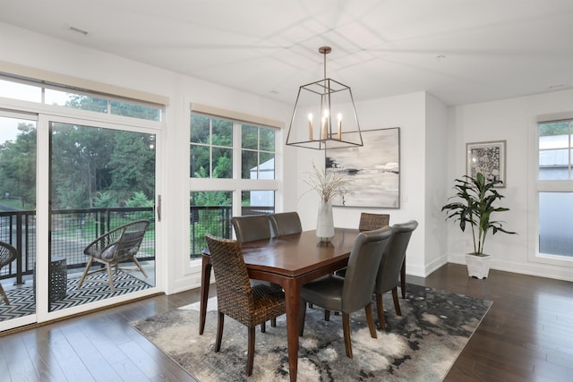 dining room featuring dark hardwood / wood-style floors, a wealth of natural light, and a chandelier