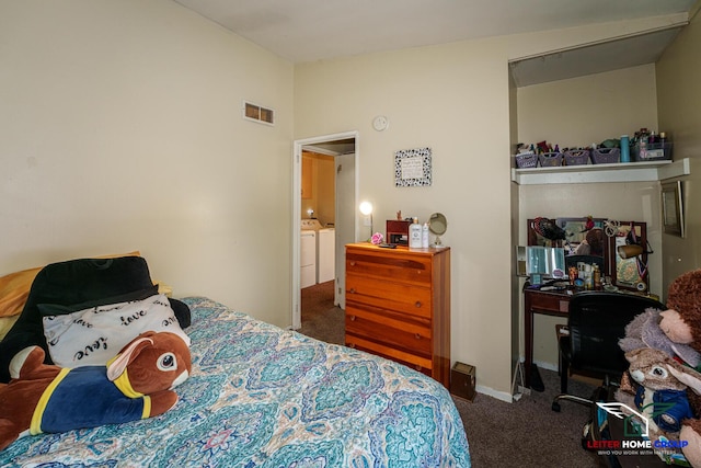 bedroom featuring independent washer and dryer, vaulted ceiling, and dark carpet