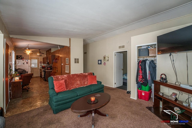 living room featuring ceiling fan, lofted ceiling, and dark colored carpet