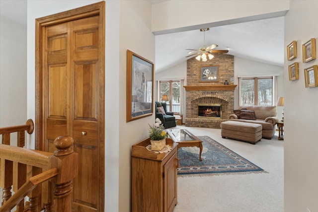 carpeted living room with plenty of natural light, ceiling fan, lofted ceiling, and a brick fireplace