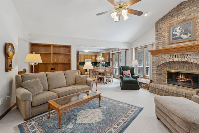 carpeted living room with a fireplace, vaulted ceiling, and ceiling fan