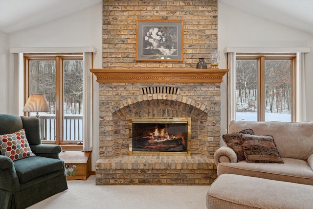 carpeted living room featuring lofted ceiling and a fireplace