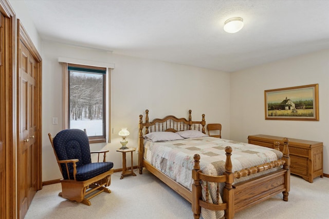 bedroom featuring light carpet and a closet