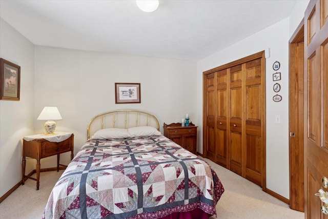 bedroom featuring light carpet and a closet