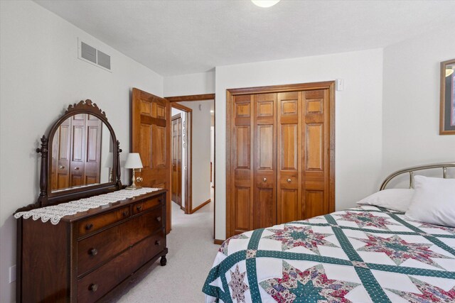 bedroom featuring light colored carpet and a closet