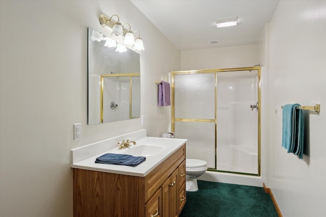 bathroom with toilet, vanity, and walk in shower