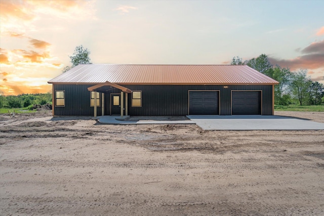 view of front of property with a garage and an outdoor structure