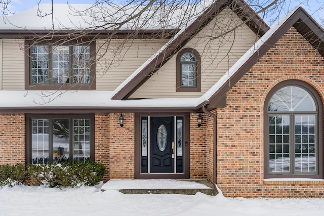 view of snow covered property entrance