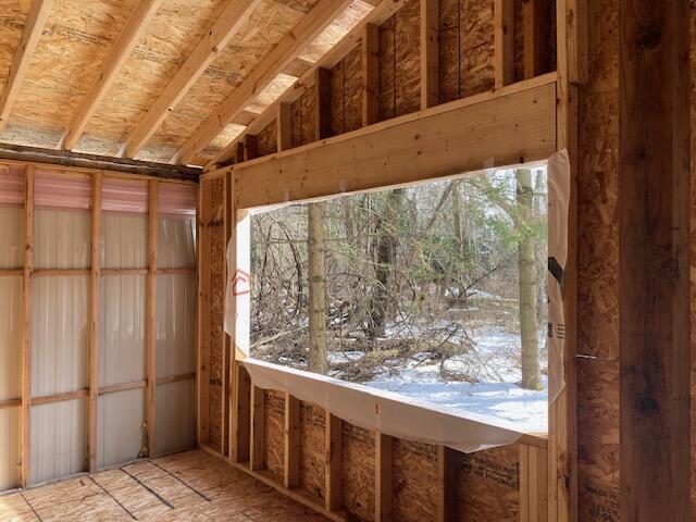 miscellaneous room with lofted ceiling