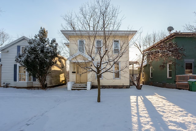 view of snow covered back of property