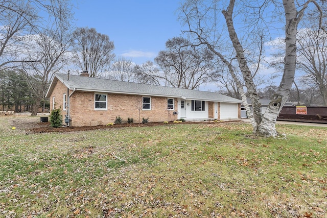 single story home featuring a front yard and a garage