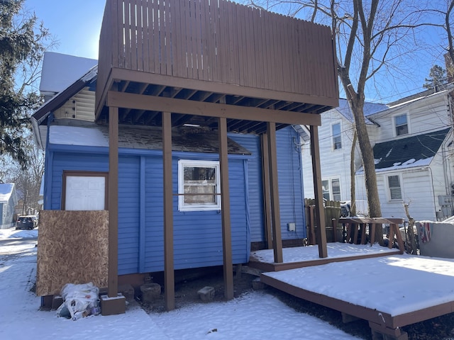 snow covered property with a wooden deck