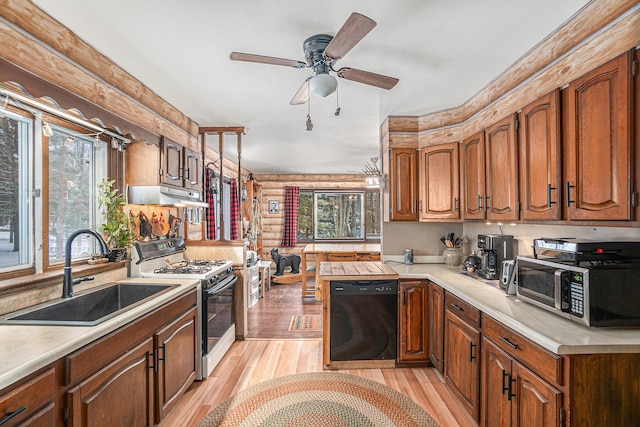 kitchen with dishwasher, rustic walls, sink, white range with gas stovetop, and light hardwood / wood-style flooring