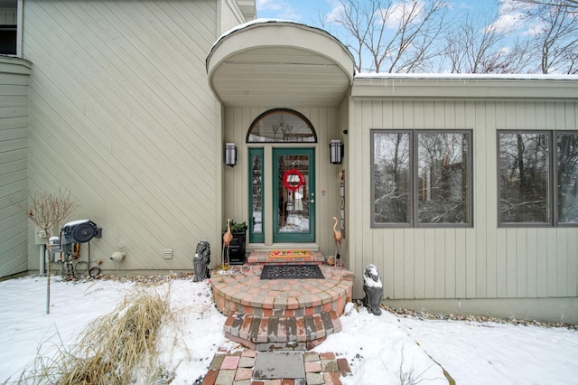 view of snow covered property entrance