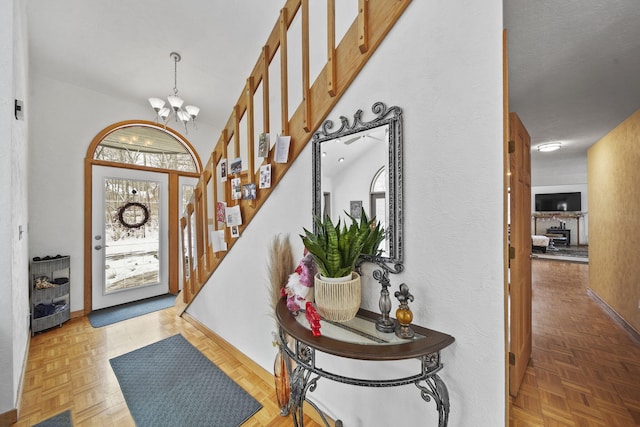 foyer featuring a notable chandelier and light parquet floors