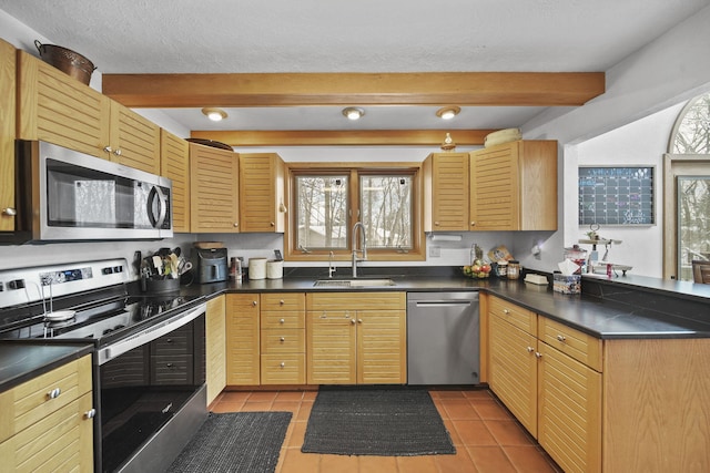 kitchen featuring light brown cabinetry, light tile patterned floors, sink, and appliances with stainless steel finishes