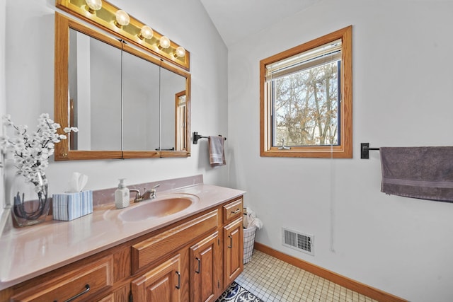 bathroom with vanity and vaulted ceiling