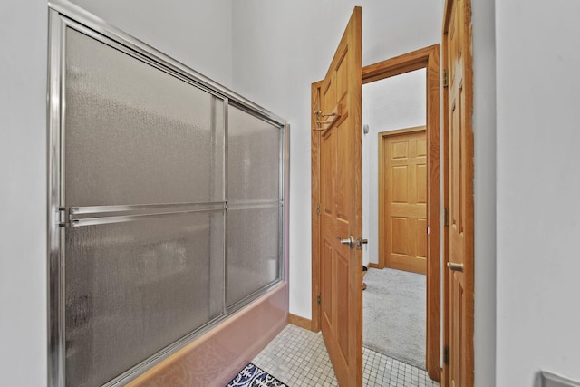 bathroom with bath / shower combo with glass door