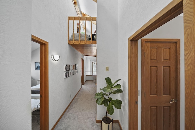 hallway with light colored carpet