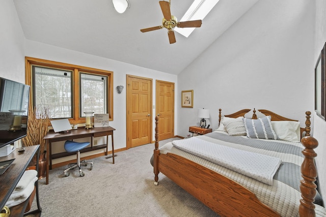 bedroom featuring light colored carpet, high vaulted ceiling, ceiling fan, and multiple closets