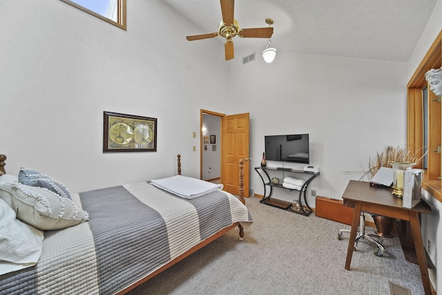 bedroom with carpet floors, ceiling fan, and high vaulted ceiling