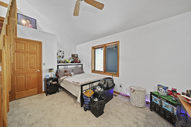 carpeted bedroom featuring ceiling fan and vaulted ceiling