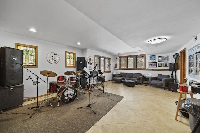 workout room featuring plenty of natural light and light tile patterned floors