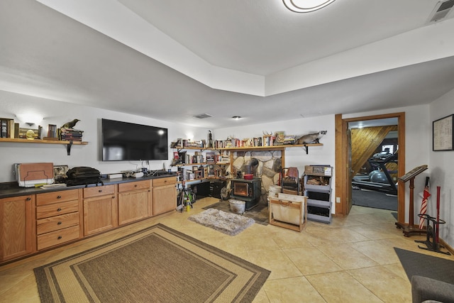 tiled living room featuring a wood stove