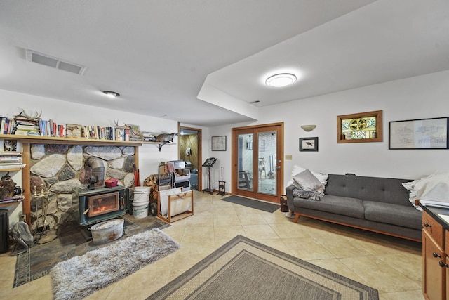 tiled living room featuring a wood stove