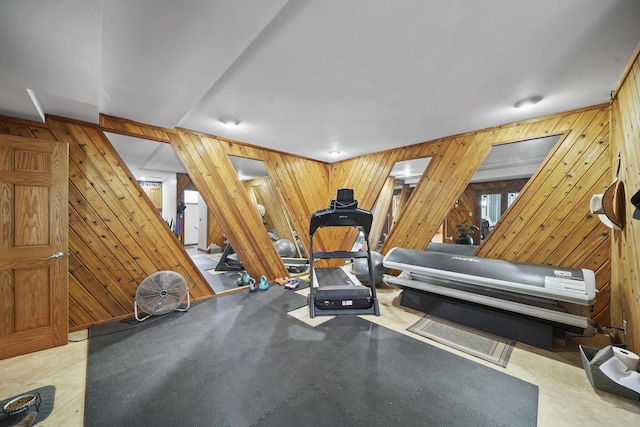 workout area featuring wood walls