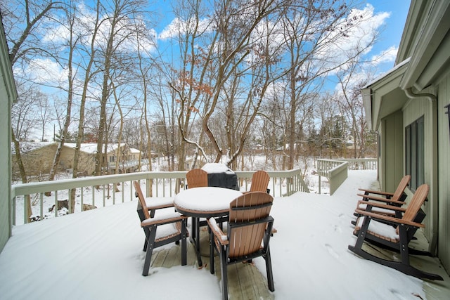 yard covered in snow featuring a deck