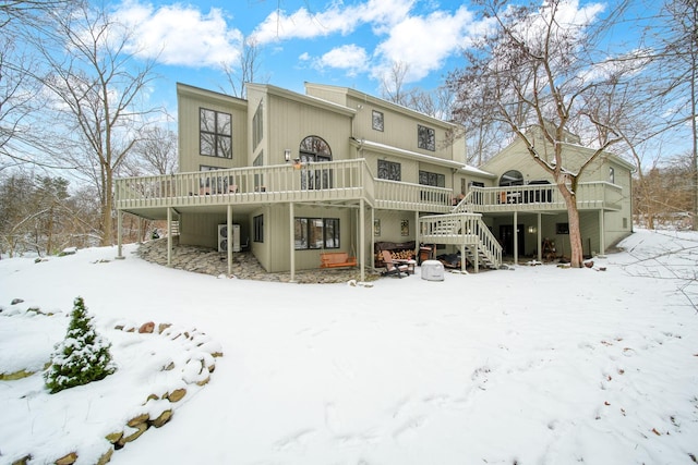 snow covered house with a deck