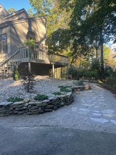 view of side of property featuring a wooden deck