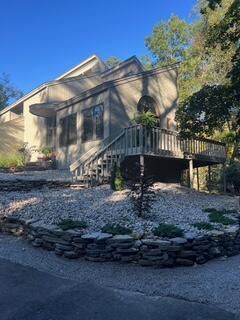 view of side of home with a deck