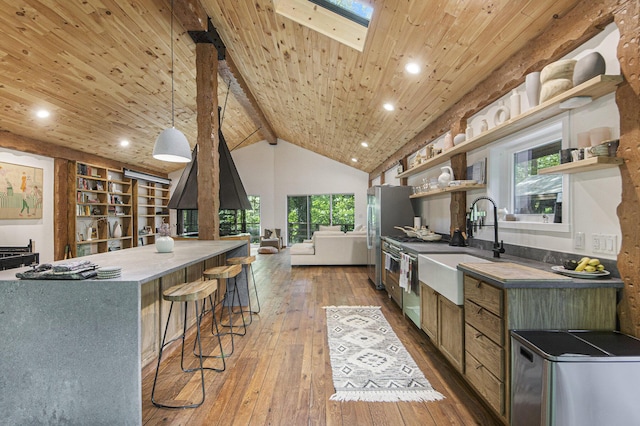 kitchen with hardwood / wood-style floors, appliances with stainless steel finishes, decorative light fixtures, and wood ceiling