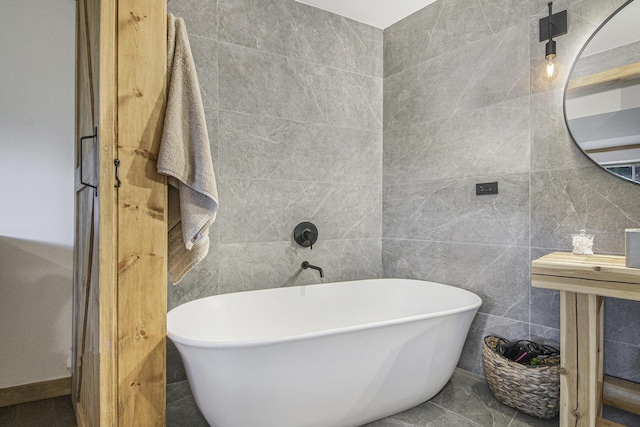 bathroom featuring a tub and tile walls