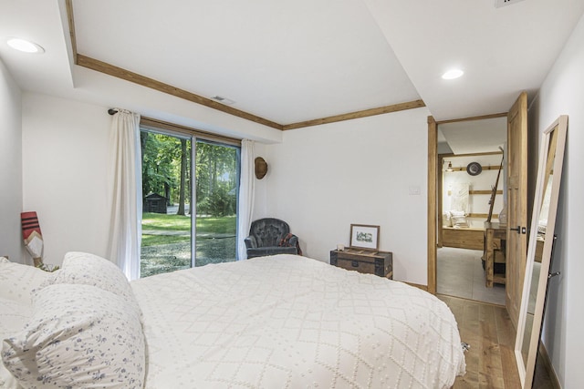 bedroom with hardwood / wood-style floors and access to outside