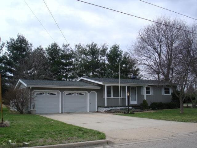 ranch-style house with a front lawn and a garage