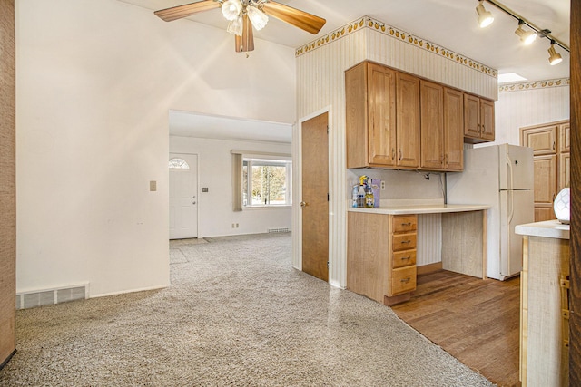 kitchen with ceiling fan, light colored carpet, and white fridge