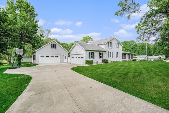 view of front of home with an outbuilding, a garage, and a front lawn