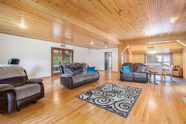 living room with french doors, light hardwood / wood-style flooring, beamed ceiling, a chandelier, and wood ceiling