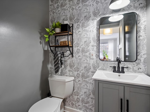 bathroom featuring toilet and vanity