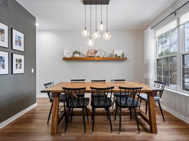 dining space with hardwood / wood-style flooring, a chandelier, and a wealth of natural light