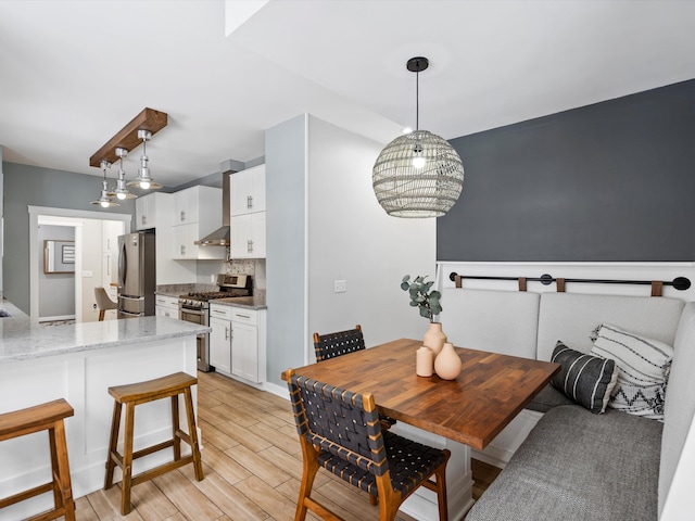 dining space featuring an inviting chandelier and light wood-type flooring