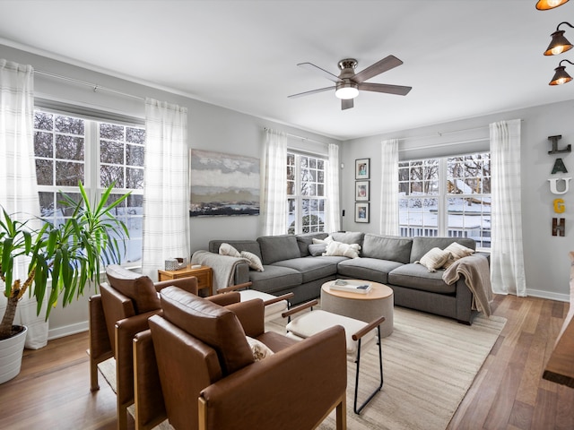 living room featuring light wood-type flooring and ceiling fan