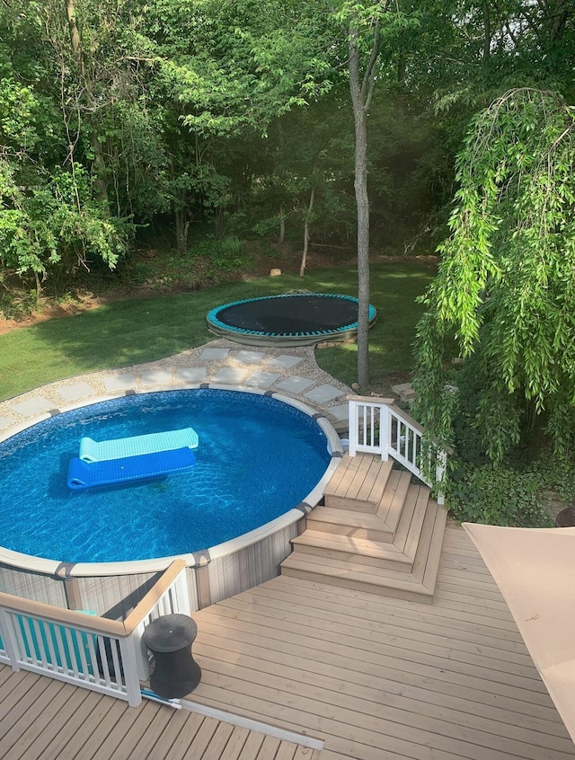 view of swimming pool featuring a wooden deck