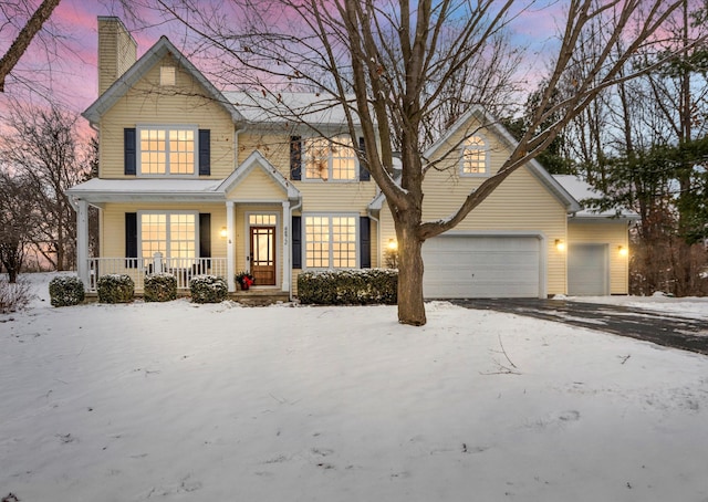 view of front of property featuring covered porch and a garage