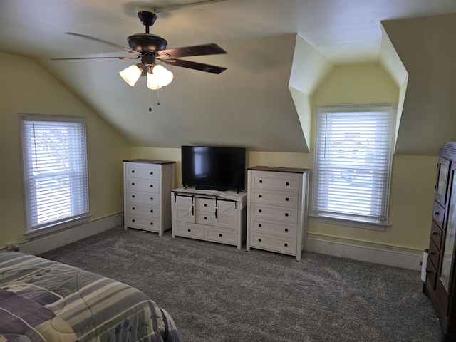 bedroom featuring ceiling fan, dark carpet, multiple windows, and vaulted ceiling